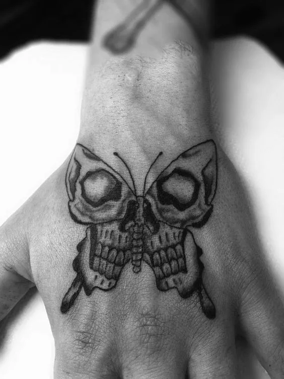 Butterfly tattoo design using some small skull tattoos.