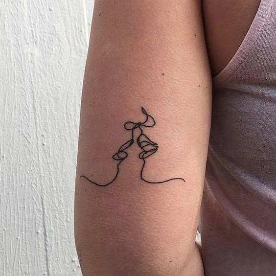 Exclusive Kiss Tattoo.