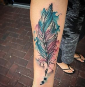 Blue And Pink Feather Tattoo On Arm