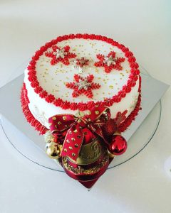 Fruit Cake Is Decorated With Red Cream Like Snoflakes