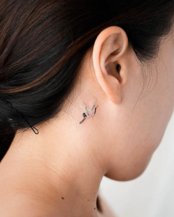 Elegant Crane Tattoo Behind the Ear