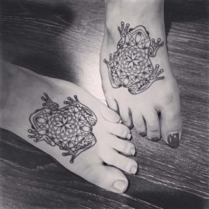 Black Line Work Elaborate Twin Frog Tattoo On Foot