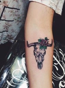 Cow skull tattoo looking on forearm very classic. - Blurmark