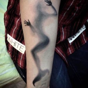 Creative shaded mermaid forearm tattoo.