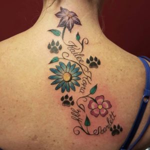 Dog paw tattoos with flowers make it feminine.