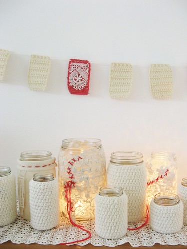 Mason jars covered with crochet yarn.