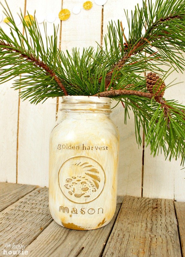 White and gold distressed mason jar decor.