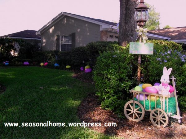 Fantastic Easter yard decor with a cart full of colorful Ester eggs and put a cute Easter bunny at the top with egg trail.