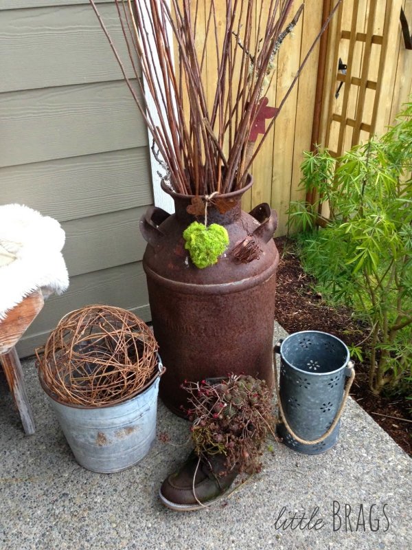 Rustic metal bucket, milk container and shoes used for outdoor decor.