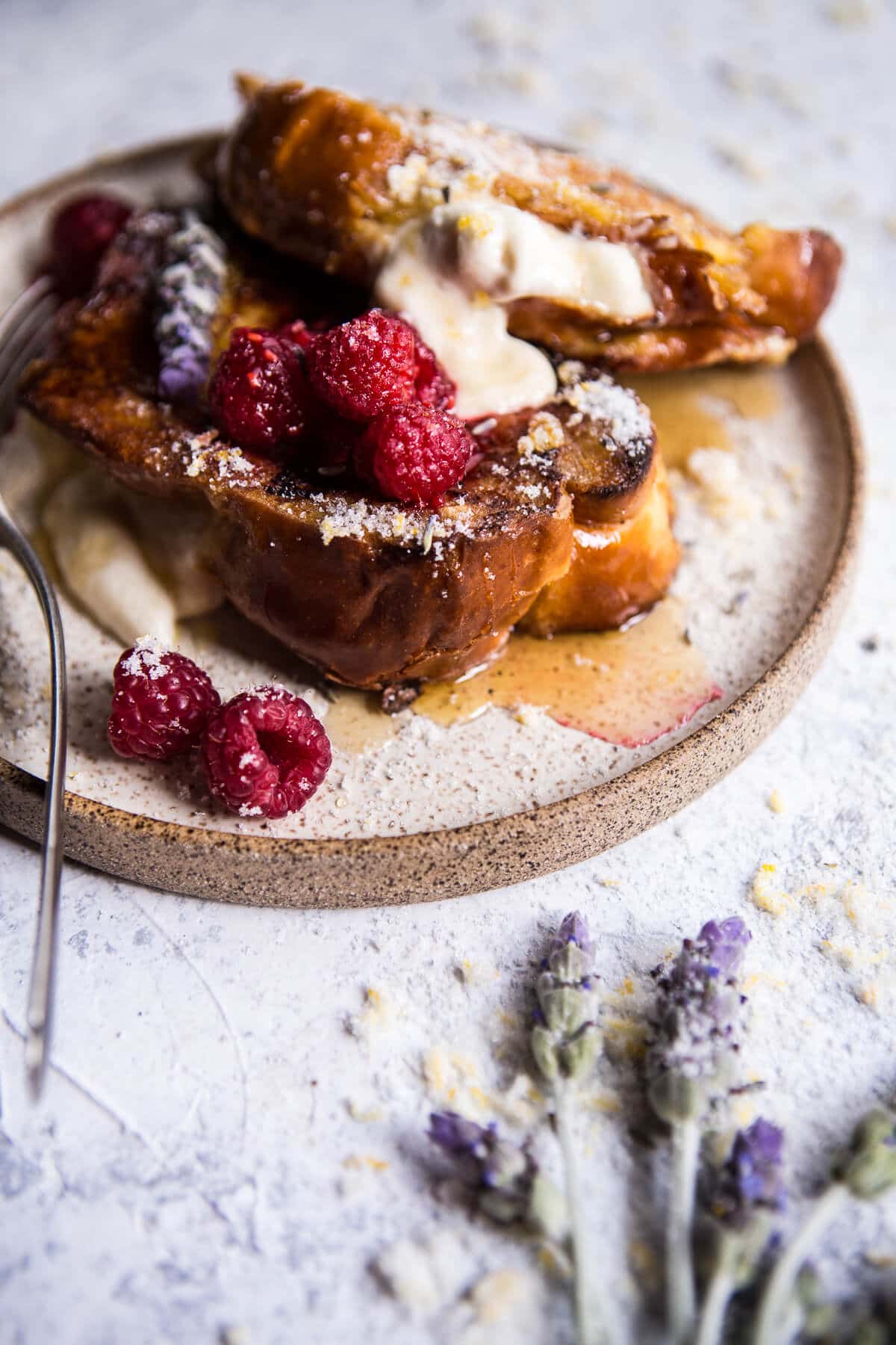 Whipped cream cheese stuffed french toast with raspberries.