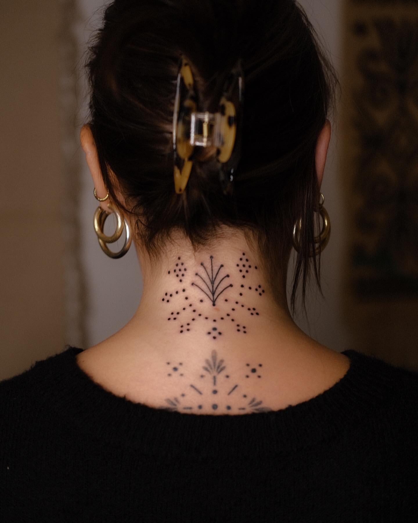 Dotted Line Work Tattoo on Back of Woman’s Neck