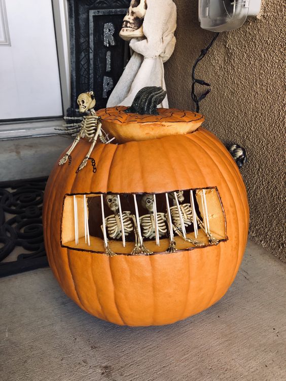 Pumpkin carving with skeleton in jail.